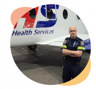 Daniel Gee stands in front of the EHS LifeFlight plane.